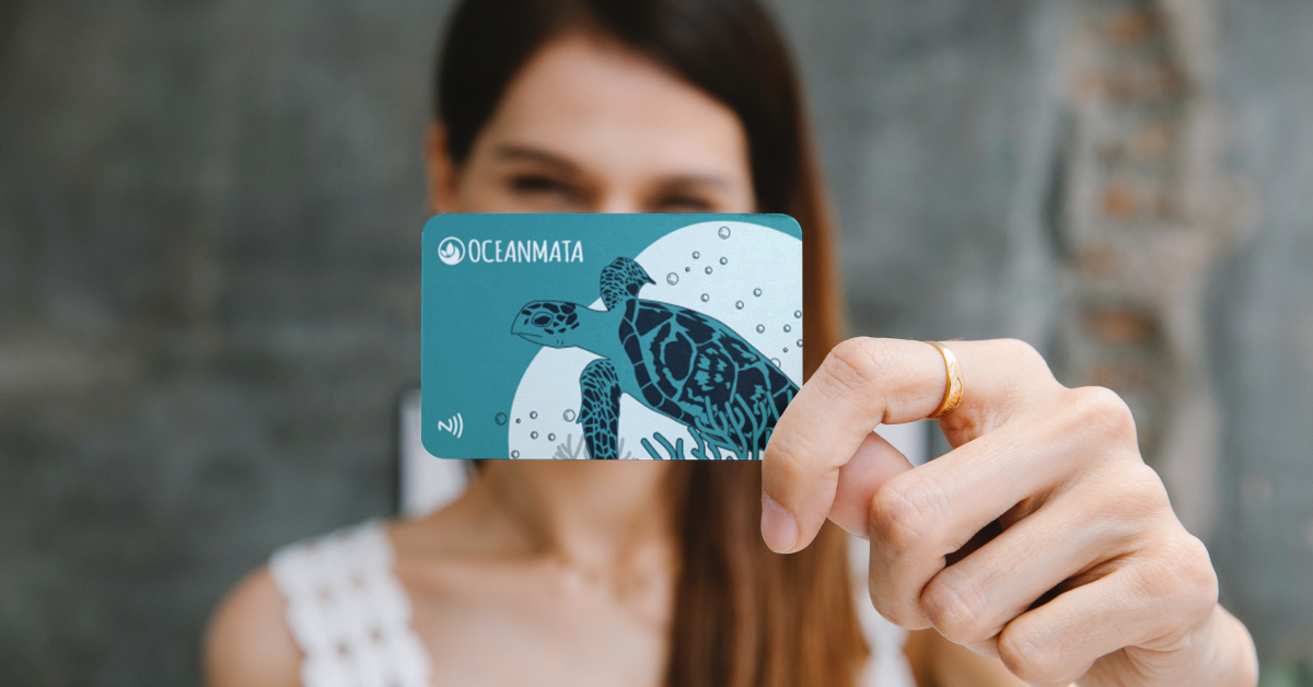 Oceanmata card from Tap2link is held up to the camera by a woman.