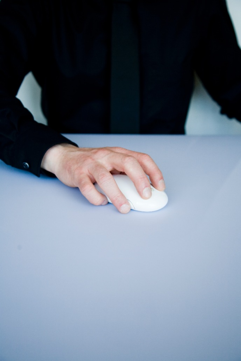 A hand on a computer mouse